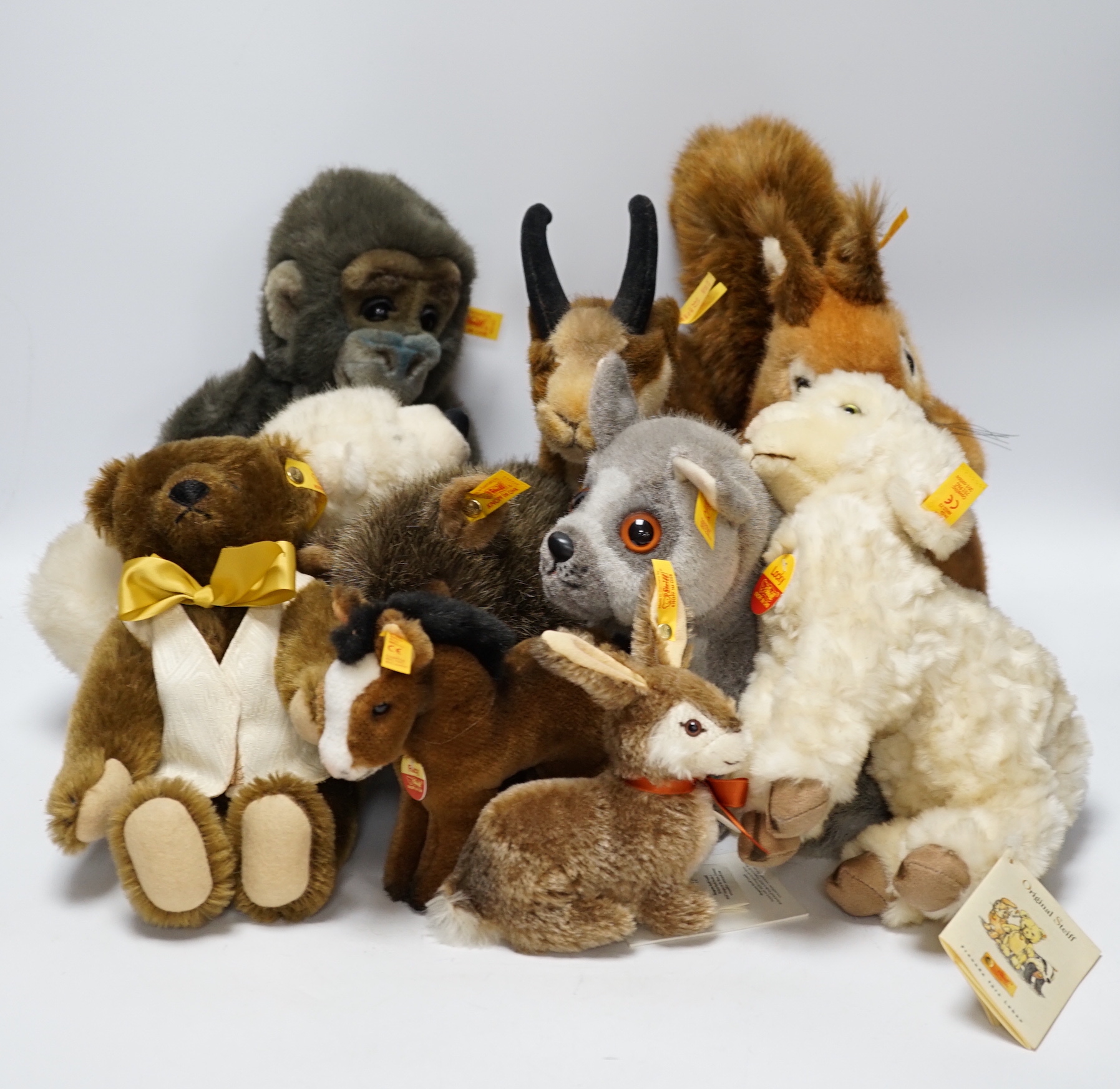 Thirteen Steiff yellow tag animals and one yellow tag bear, including Snorry fox, Mannie rabbit, Nagy beaver and Resi cow